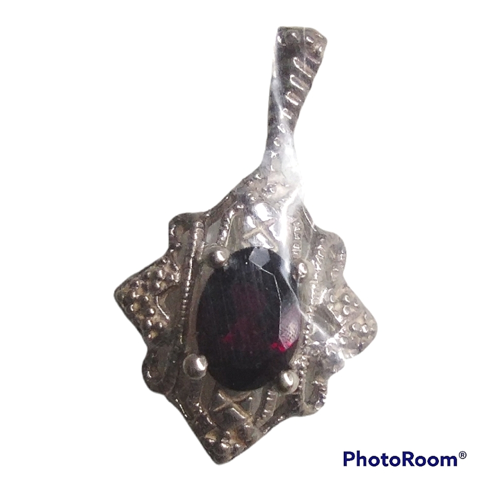 Purple colored pendant with silver chain and black ribbon Avon new in box